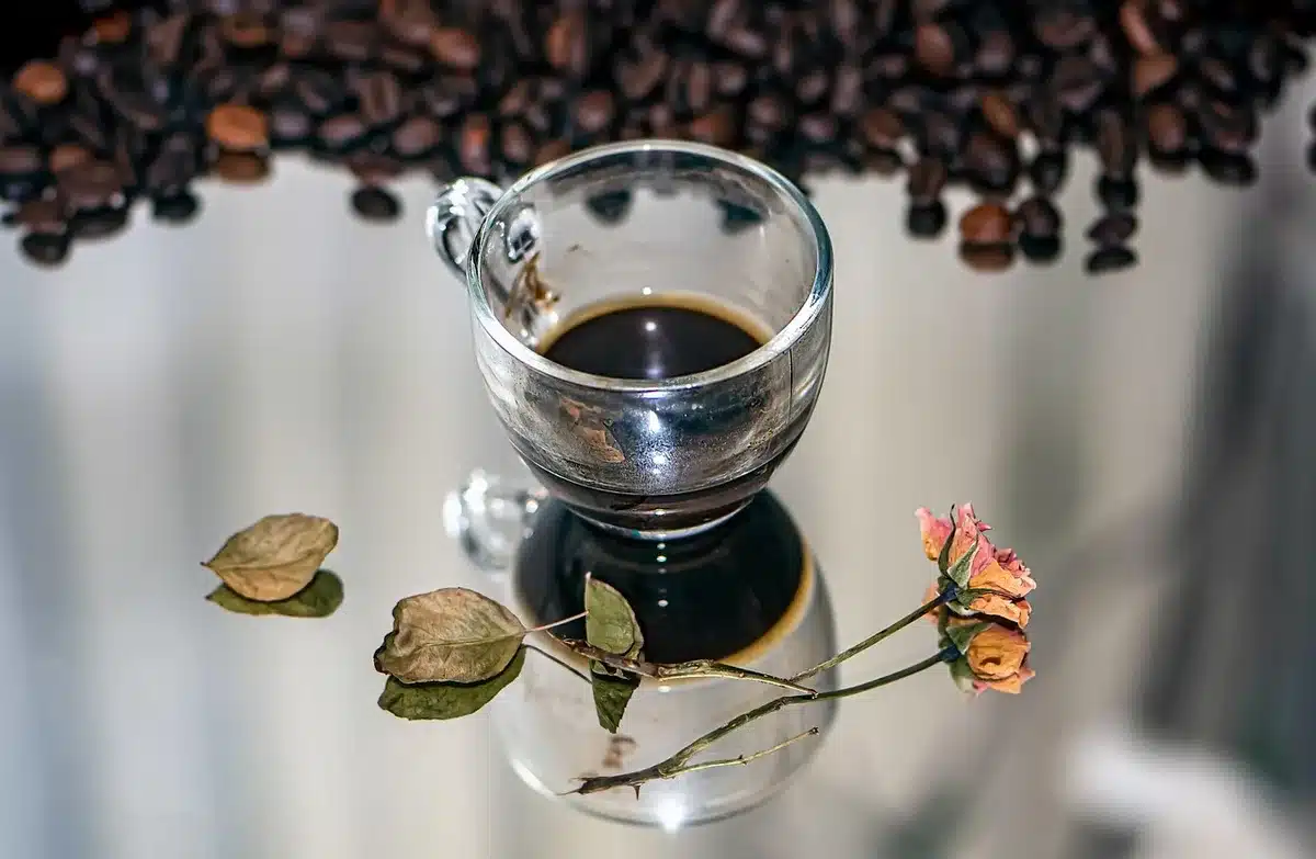 A cup of coffee with a clock showing morning time