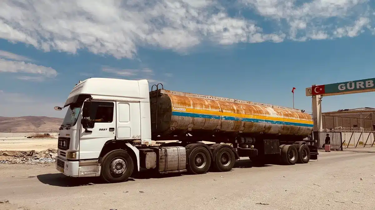 Cargo truck crossing a border, representing integrated cross-border trade networks between Canada and the US.