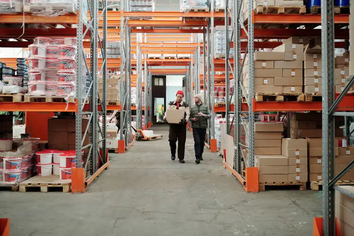 Warehouse with stacked boxes and inventory, showing supply chain operations affected by tariffs.