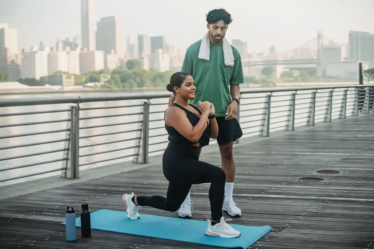 Worker in standing lunge position with upright torso, stretching hip flexors and calves.