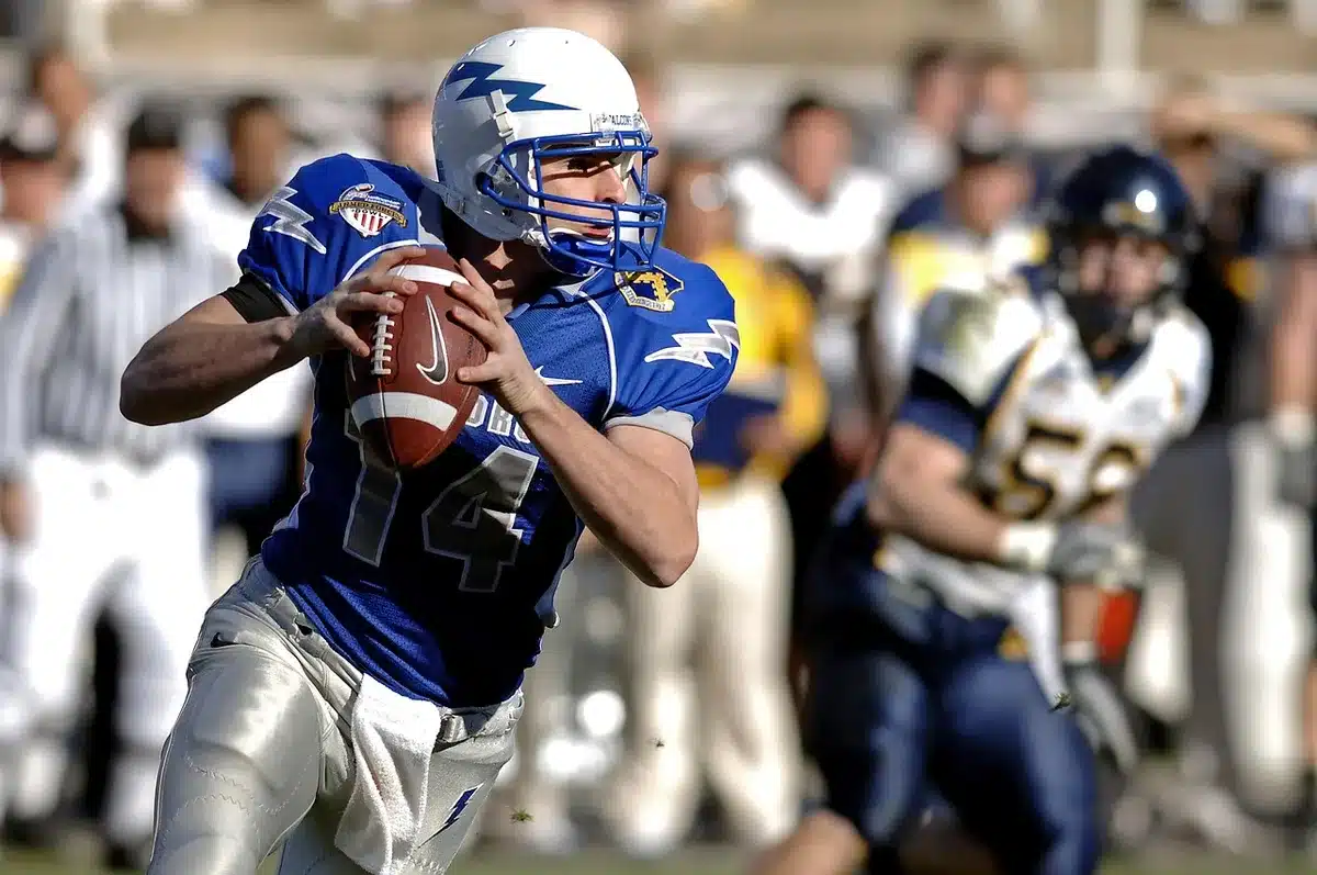 Quarterback protected by offensive linemen in pocket