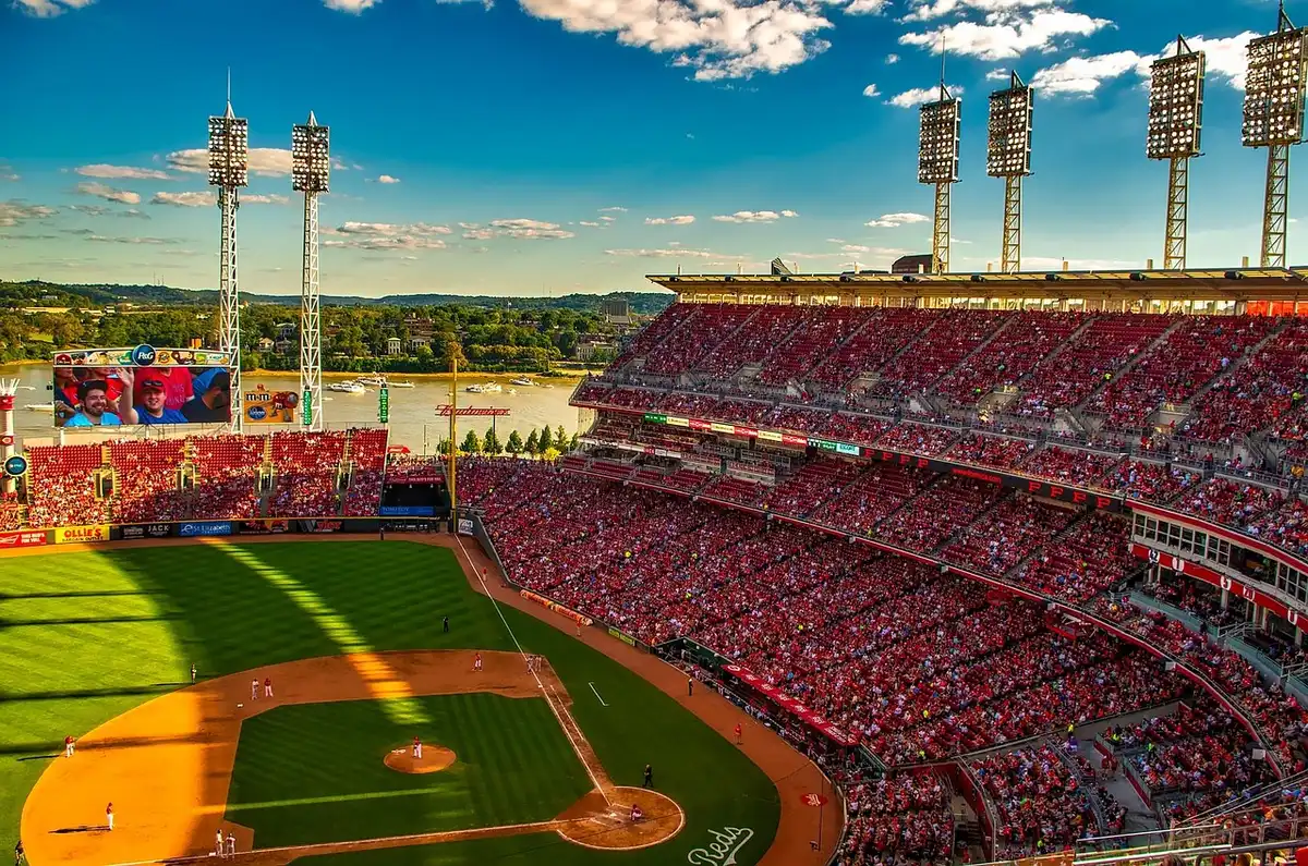 Baseball stadium with fans watching playoff standings on scoreboard during tight wild-card race