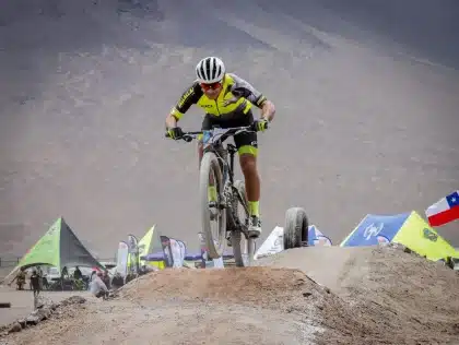 Two cyclists on a long-distance bike ride across varied terrain toward a distant city skyline
