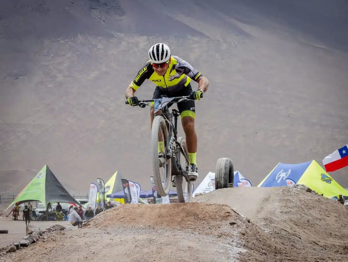Two cyclists on a long-distance bike ride across varied terrain toward a distant city skyline