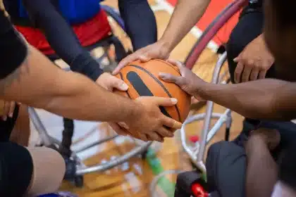 NBA players huddle in locker room before game, preparing for upcoming season