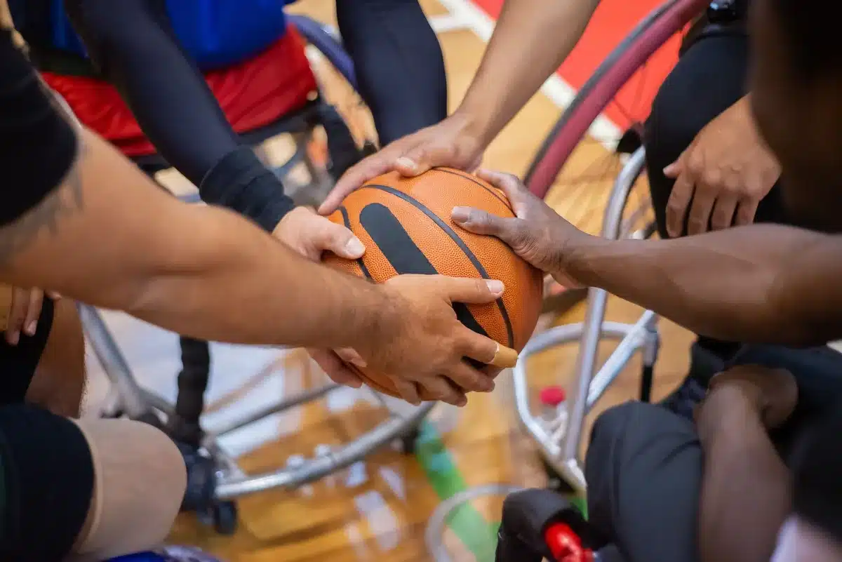 NBA players huddle in locker room before game, preparing for upcoming season