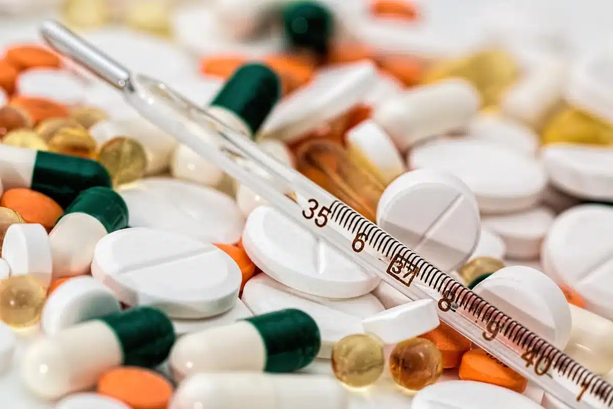 Person experiencing fever and headache symptoms that may indicate PAM infection.