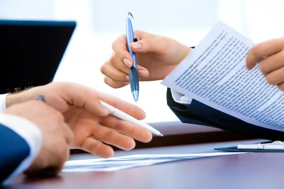NBA front-office personnel reviewing trade documents and roster details