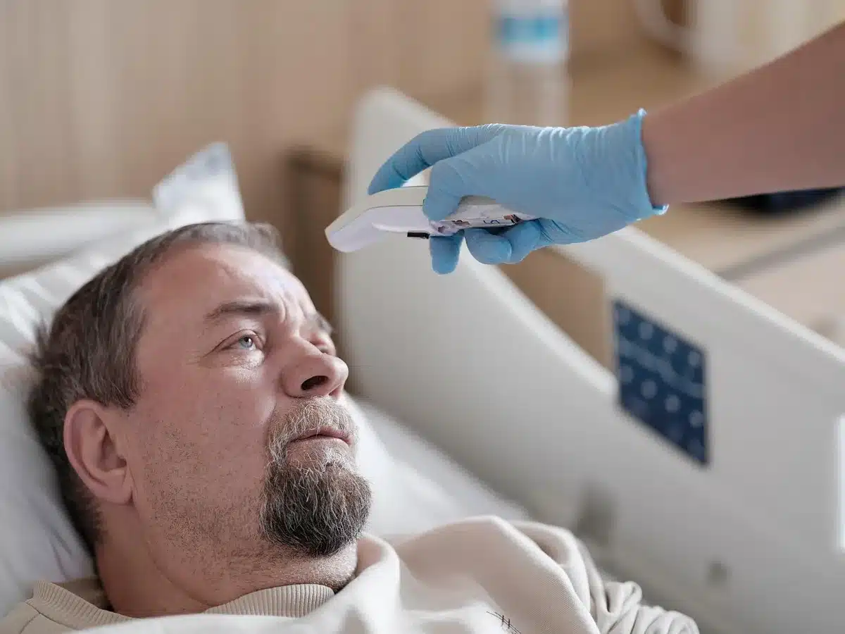 Nurse explaining treatment to a patient in a hospital room