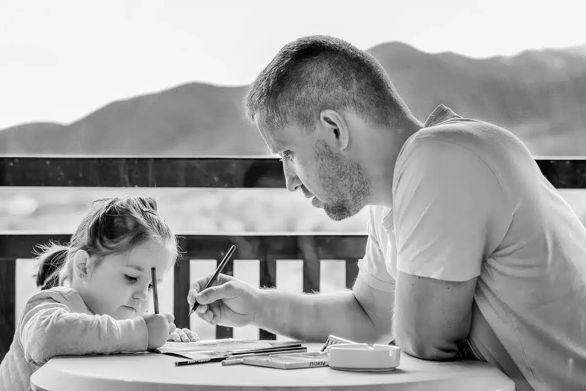 Parent organizing therapy notes and appointment logs at a kitchen table