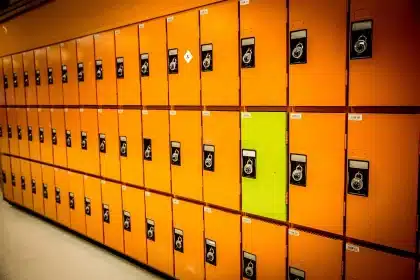 Empty elementary school hallway with backpacks and shoes by lockers