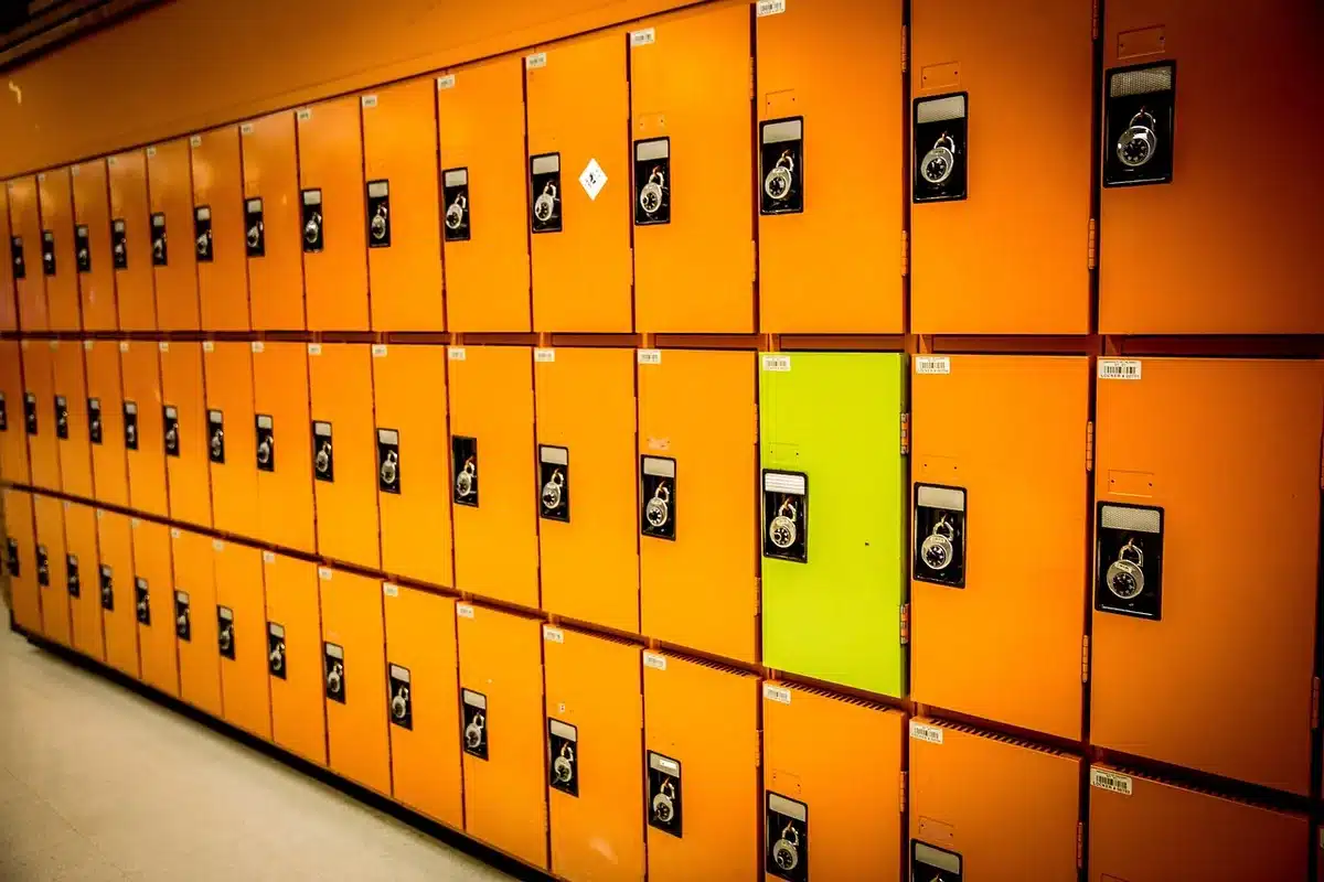 Empty elementary school hallway with backpacks and shoes by lockers
