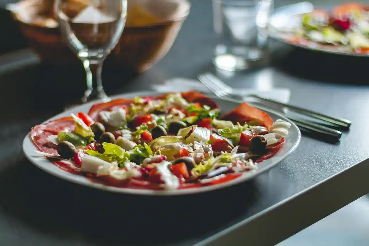 Hands arranging a simple home-cooked plate beside walking shoes on a sunlit kitchen table