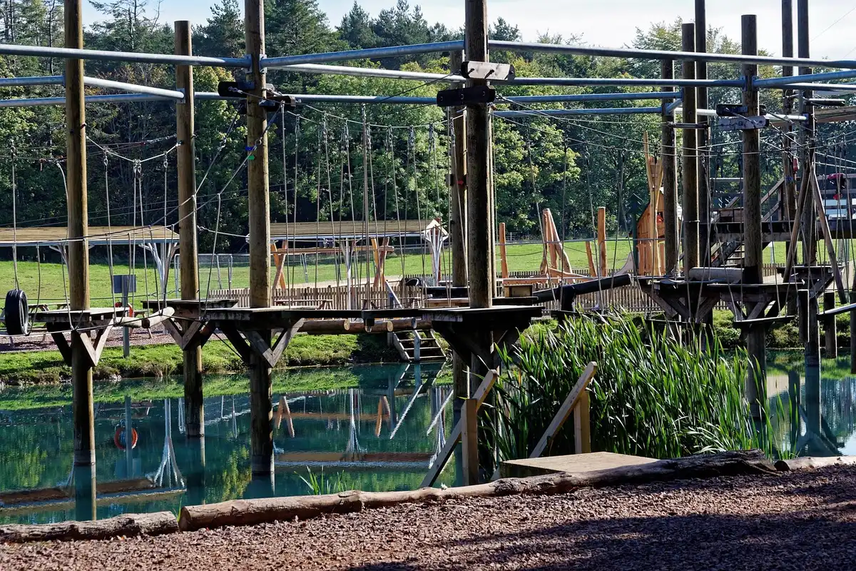 Children navigating an outdoor obstacle course on grass