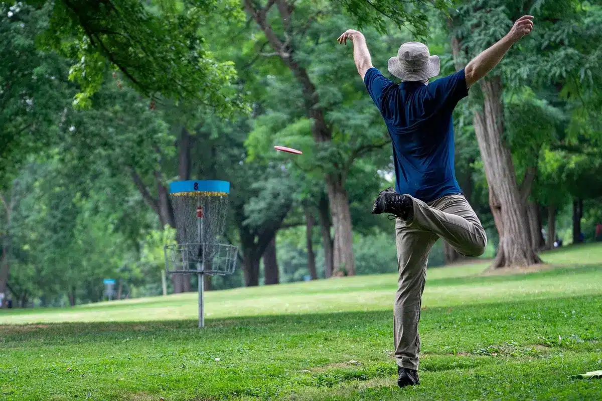 Young golfer pumping fist after sinking a decisive putt
